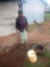 Mixing mud, water and sawdust together by foot