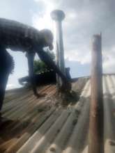 Chimney made of tin is fit through the roof