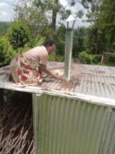 Nancy fixing the chimney on the roof