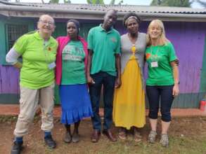Volunteers with home owner and stove installers