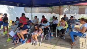 Class includes teachers, a doctor, and children