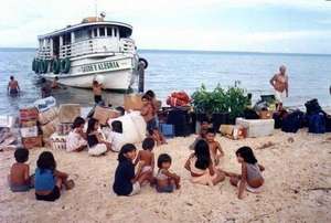 Boat arriving and children at the beach