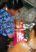 Artisan sharing her knowledge of weaving in a clas