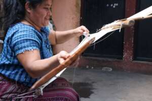 Artisan weaving on backstrap loom