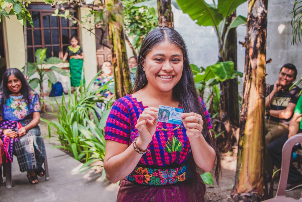 A weaver with her new health insurance card 2026