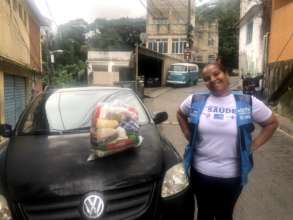 Miriam, the health clinic director delivering food