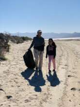 Aventureros participating in a beach cleanup