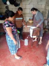Beneficiary family receiving drinking water filter