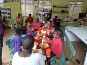 children at MHO enjoying nutritious food