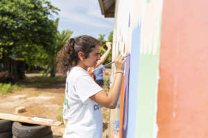 Young volunteer painting the walls