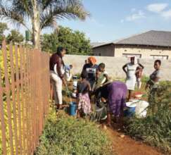 Community members in line for water from our well.