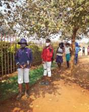 Kids lining up for to-go meals during lockdown