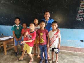 Teacher and children-recipients of school supplies