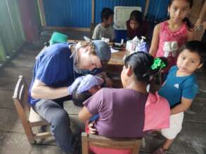 Examining a young patient under mom's watchful eye