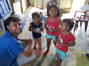 Medical volunteer with children, Nanay River, Peru