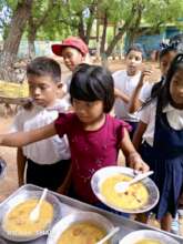 Children in line getting their meals.