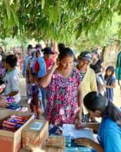 People receiving a donation of hygiene products.