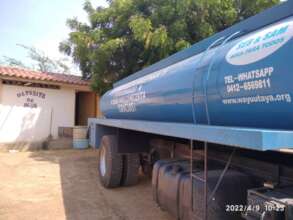 The water truck delivering free water to a school
