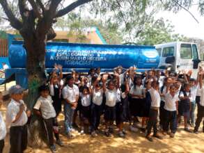 Children at a school receiving water.