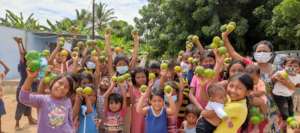 A group of children receving fruits