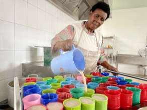 Mama Martha Serving Porridge at Breaktime