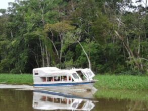 volunteers make river observations on a small boat