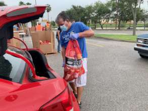 Volunteer Loads Emergency Food