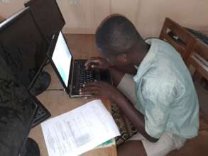 Student working with donated laptop