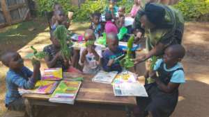 Girls study outdoors with their tutor