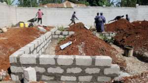 Construction workers laying foundation