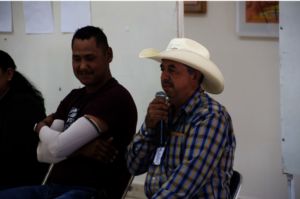 Community leader Omar listens while friend speaks