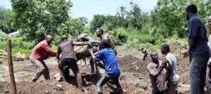 community members clearing site for construction