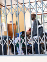 Baby being weighed in open-air waiting area