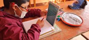 Child using a tablet to access online classes