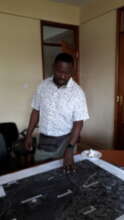 Dr. Nkoba Kiatoko, ICIPE, with project area map