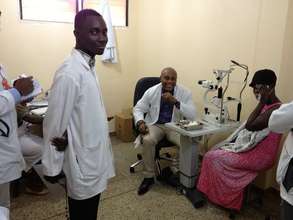 Dr. Peter Armah examining a patient