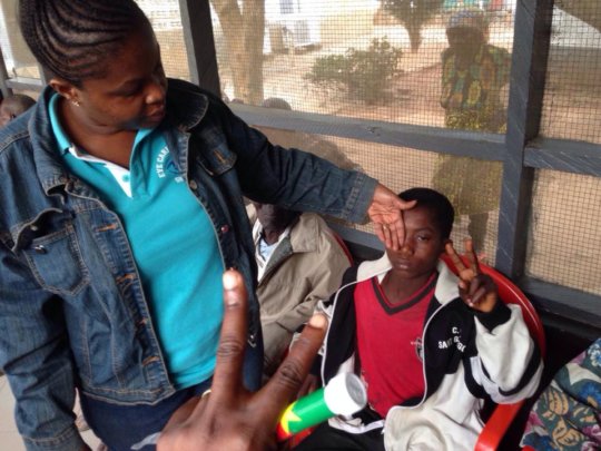 Dr. Frimpong examines patient