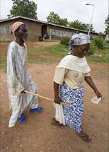 A woman leading a blind patient