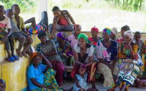 Adele(green headscarf) speaks at Pama Kaci meeting