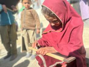 Student writes on Mini Chalk board in Kurram