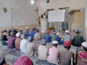 A cleric teaching students using Dosti Whiteboard