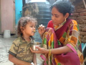 Mother feeding her son