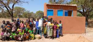 Primary school girls in front of the tiled latrine