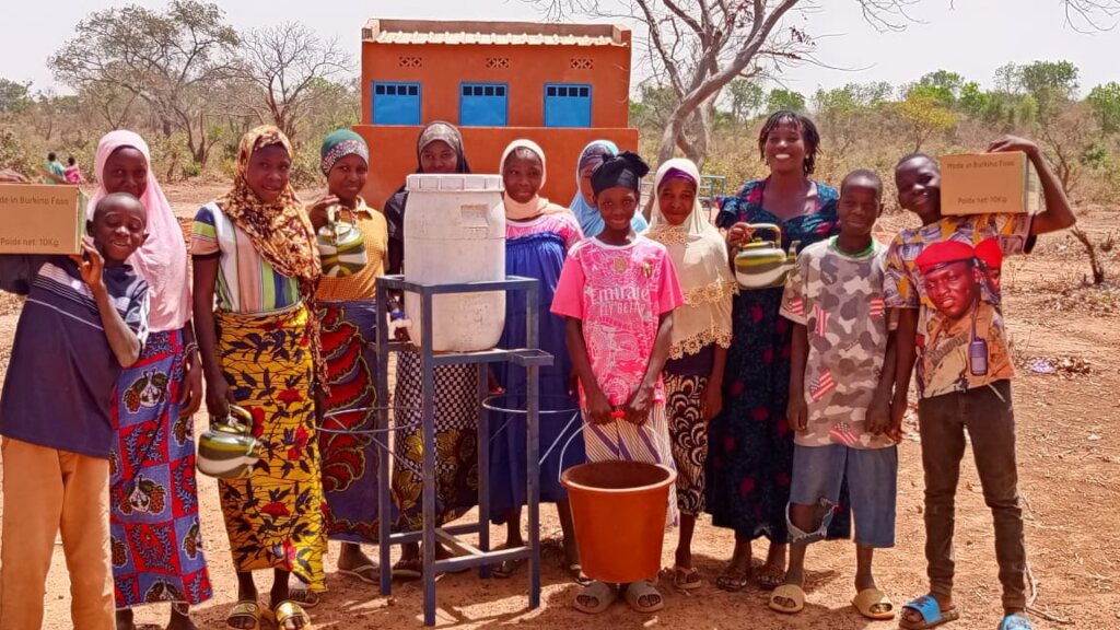 Girls in font of their new latrines