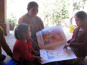Hermalinda enjoying a picture book with her family
