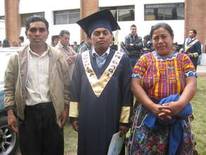 Luis with his parents at graduation