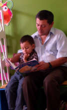 Father and son reading together