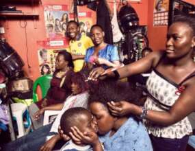 WOMEN PRACTICING HAIR DRESSING