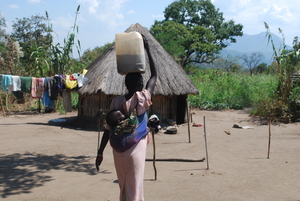 Carrying 20 liter jerry - can water & a baby