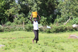 One of the OVC collecting water for her family